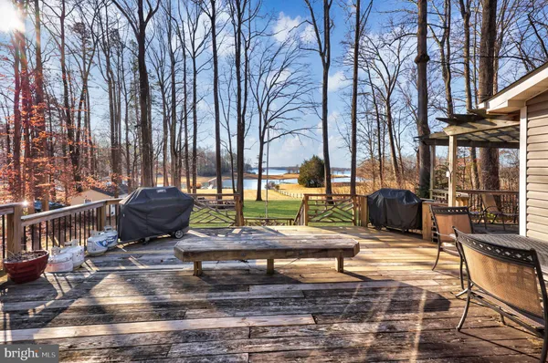 a view of a chairs and table in the backyard