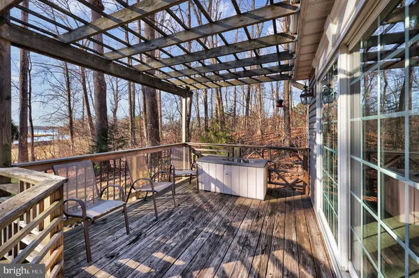 a view of balcony with wooden floor and fence
