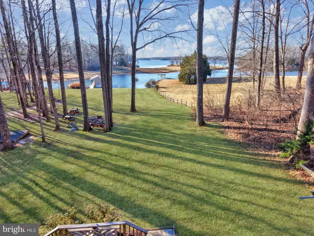 a kitchen with stainless steel appliances granite countertop a stove a sink dishwasher a refrigerator and cabinets with wooden floor