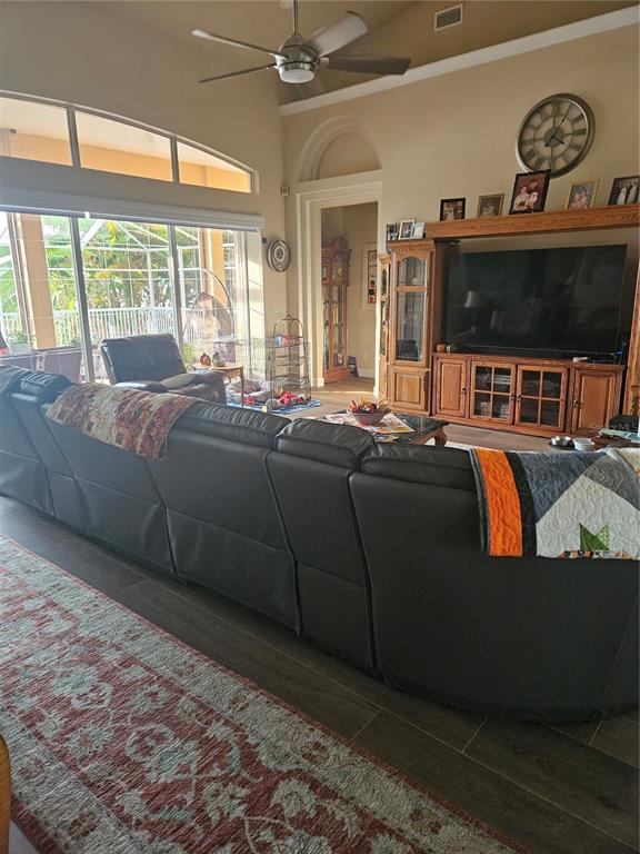 116 Raintree Court Auburndale, FL 33823 - Photo 11 of 45 a living room with furniture a flat screen tv and a large window