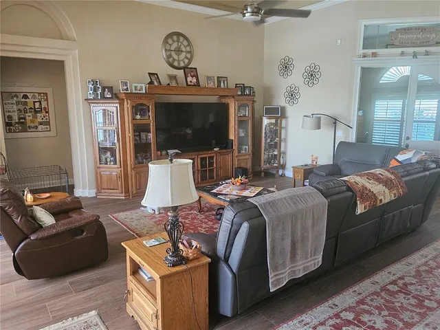 a living room with furniture windows and a flat screen tv