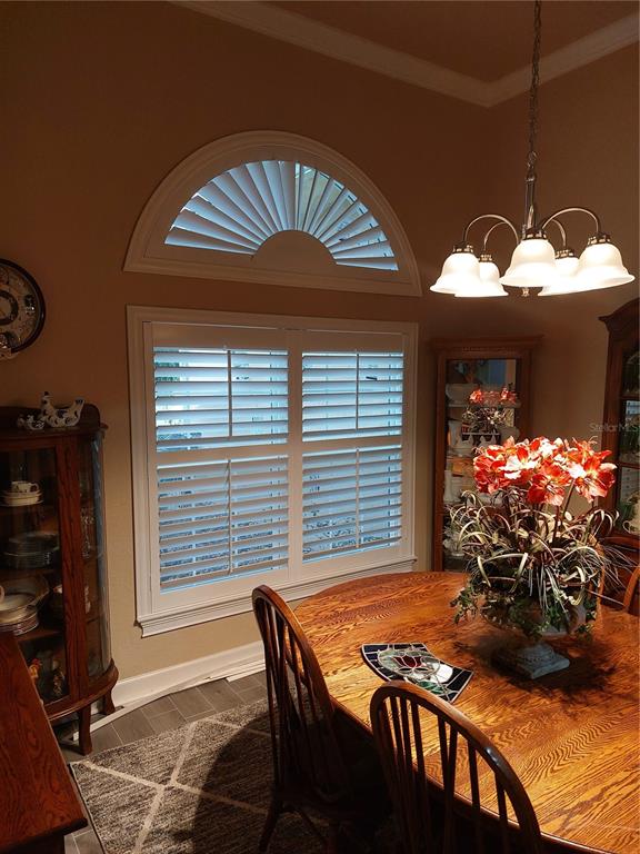 116 Raintree Court Auburndale, FL 33823 - Photo 13 of 45 a view of a dining room with furniture and a window