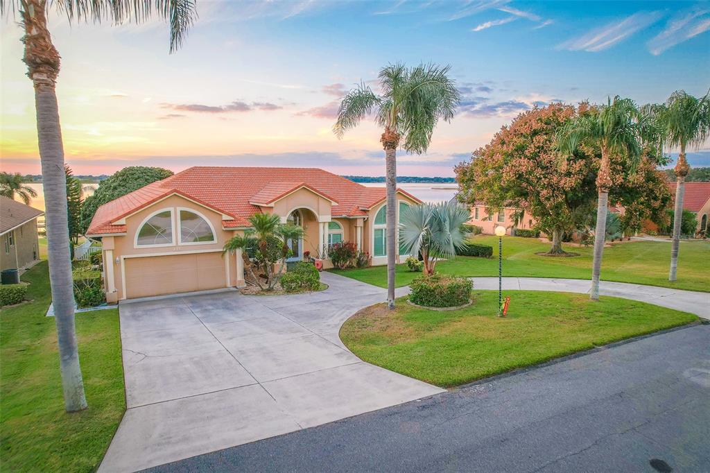 116 Raintree Court Auburndale, FL 33823 - Photo 2 of 45 a view of a house with a swimming pool and a yard