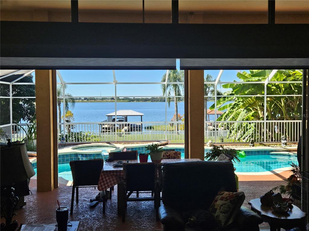 116 Raintree Court Auburndale, FL 33823 - Photo 36 of 45 a dining room with furniture and a floor to ceiling window
