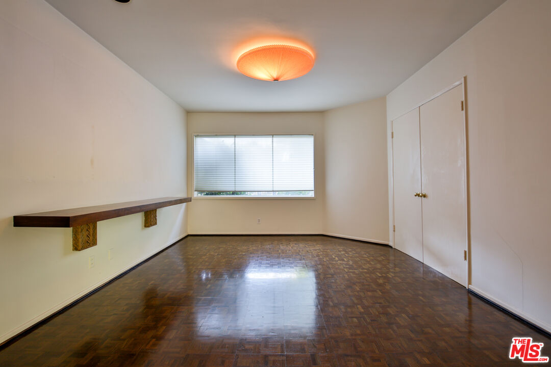 1749 Mandeville Lane Los Angeles, CA 90049 - Photo 12 of 38 a view of an empty room with window and wooden floor