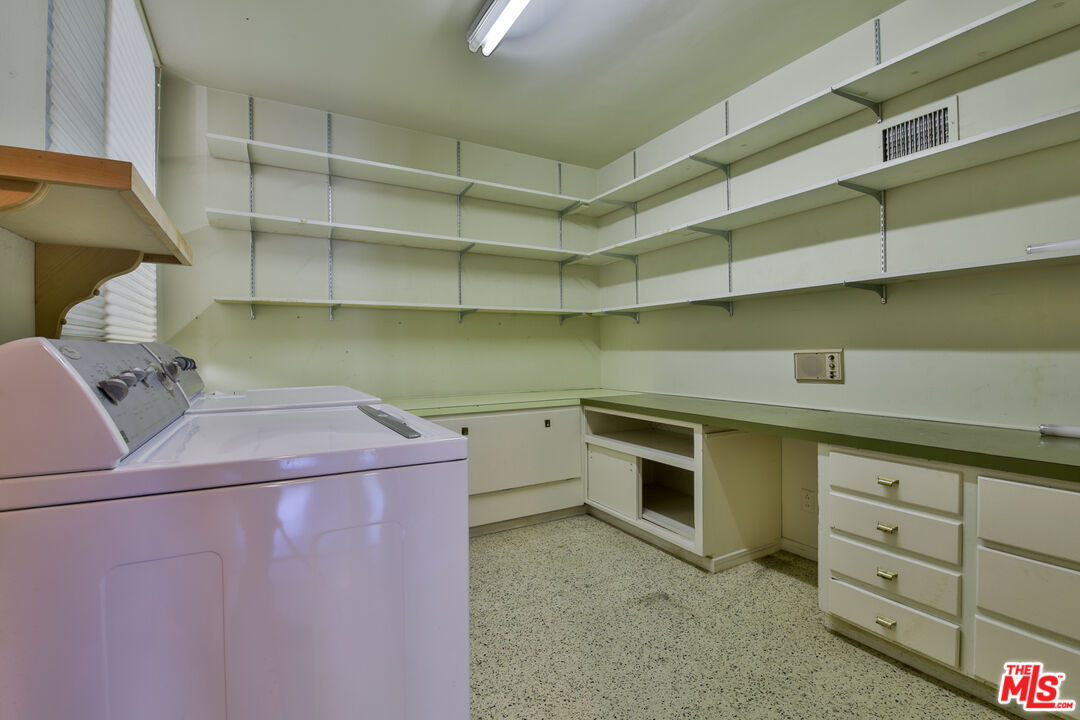 1749 Mandeville Lane Los Angeles, CA 90049 - Photo 14 of 38 a utility room with cabinets washer and dryer