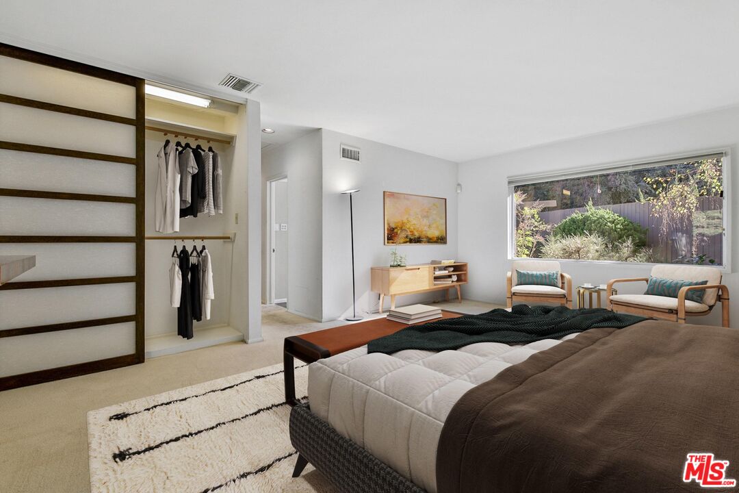 1749 Mandeville Lane Los Angeles, CA 90049 - Photo 18 of 38 a bedroom with a bed and wooden floor