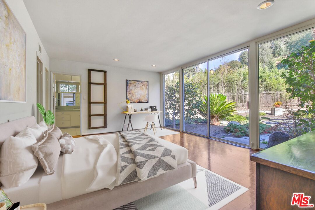 1749 Mandeville Lane Los Angeles, CA 90049 - Photo 20 of 38 a bedroom with a large bed and a potted plant