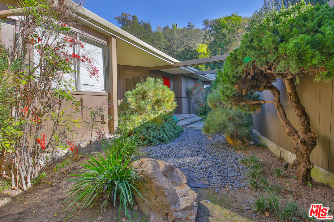 1749 Mandeville Lane Los Angeles, CA 90049 - Photo 26 of 38 a front view of a house with a yard