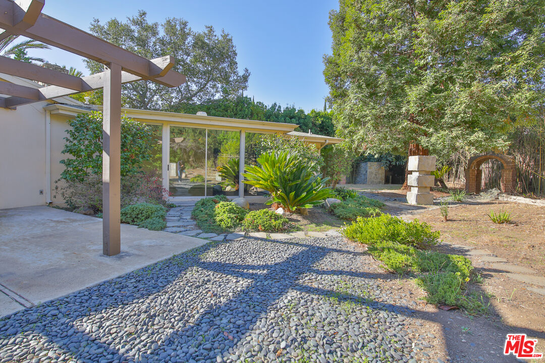 1749 Mandeville Lane Los Angeles, CA 90049 - Photo 27 of 38 a view of a garden with a patio
