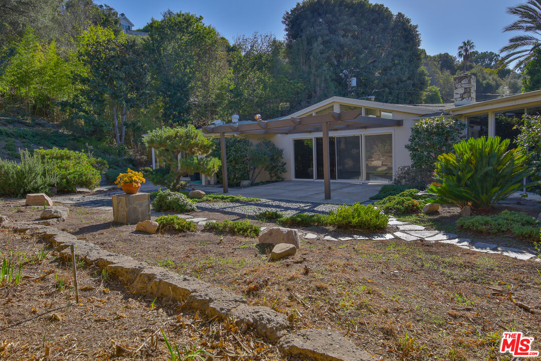 1749 Mandeville Lane Los Angeles, CA 90049 - Photo 30 of 38 a front view of a house with garden