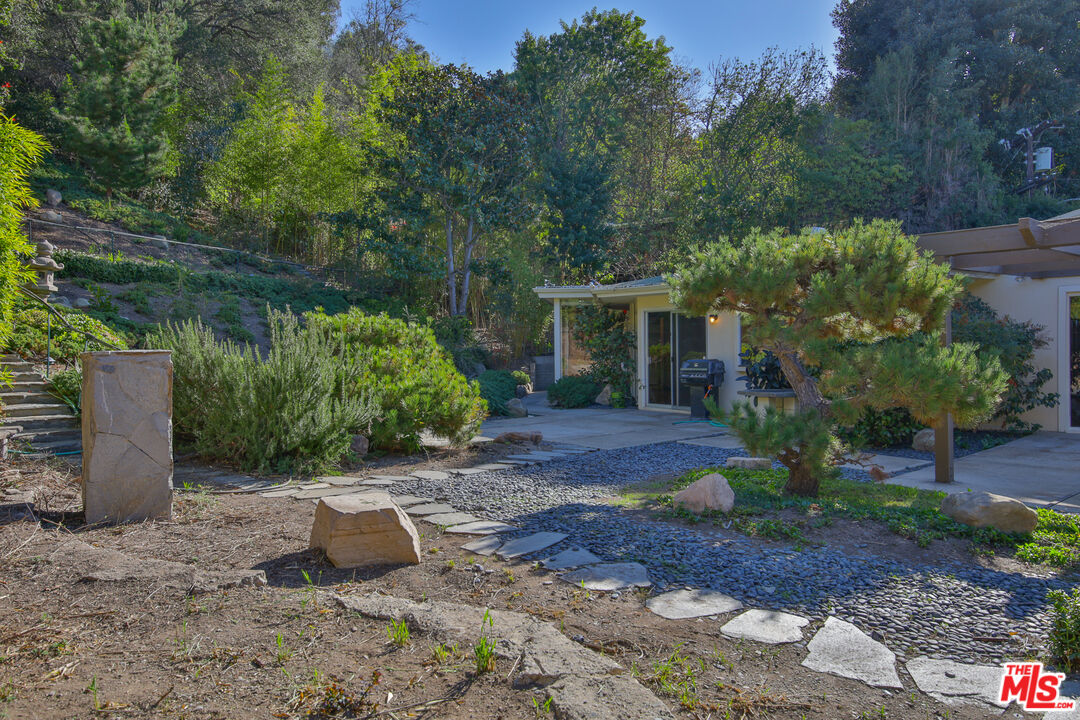 1749 Mandeville Lane Los Angeles, CA 90049 - Photo 31 of 38 a view of a house with a yard and tree s