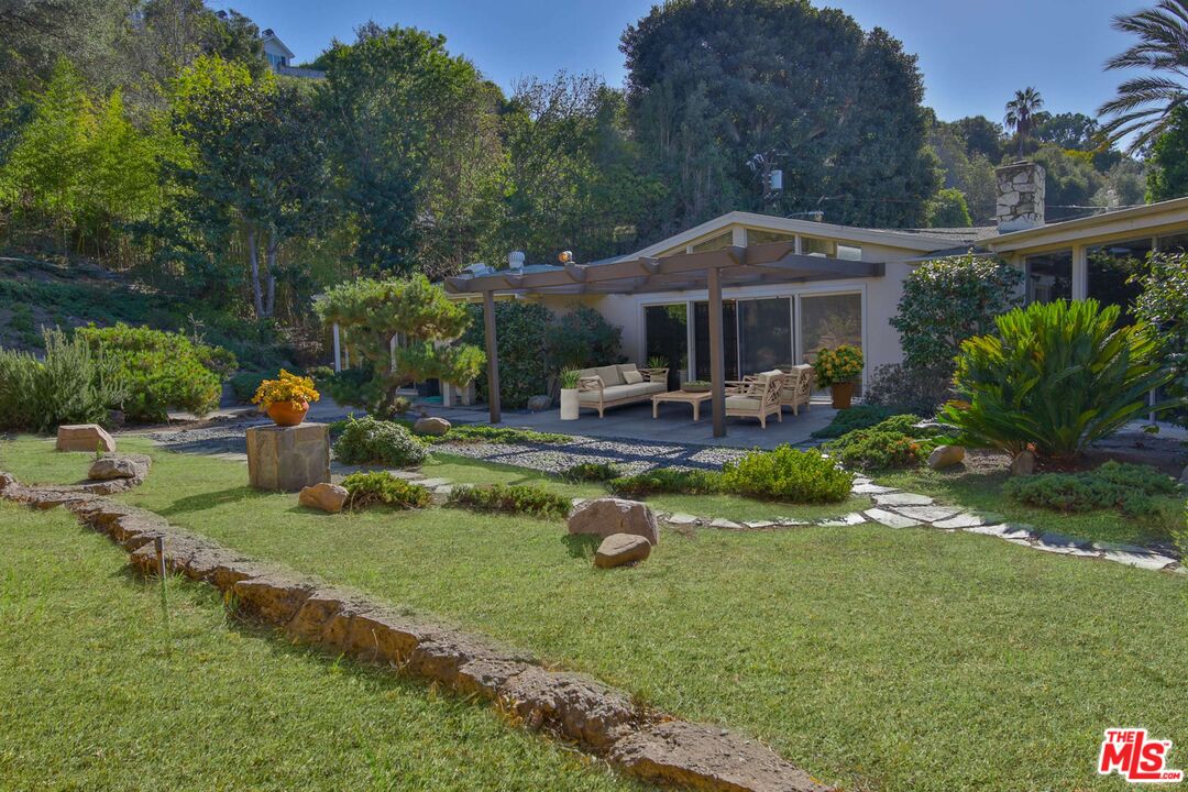 1749 Mandeville Lane Los Angeles, CA 90049 - Photo 34 of 38 a front view of a house with garden