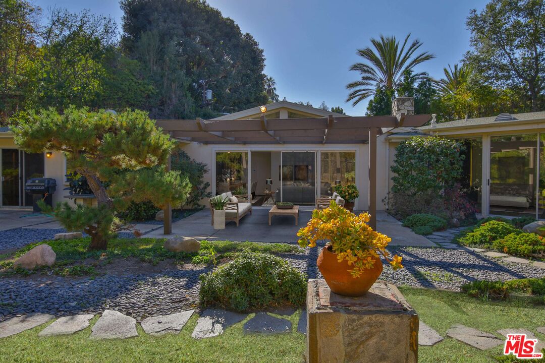 1749 Mandeville Lane Los Angeles, CA 90049 - Photo 35 of 38 a front view of a house with garden and sitting area