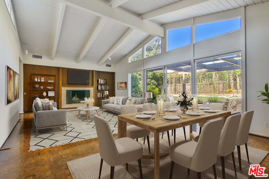 1749 Mandeville Lane Los Angeles, CA 90049 - Photo 5 of 38 a view of a dining room with furniture large windows and wooden floor