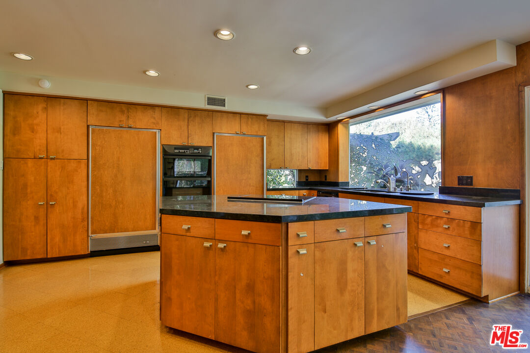 1749 Mandeville Lane Los Angeles, CA 90049 - Photo 7 of 38 a kitchen with stainless steel appliances granite countertop a stove a sink and a refrigerator