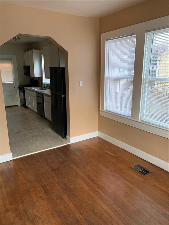 2714 Whitis Avenue, Unit ABC Austin, TX 78705 - Photo 2 of 24 Kitchen with black appliances, light wood finished floors, and dark countertops