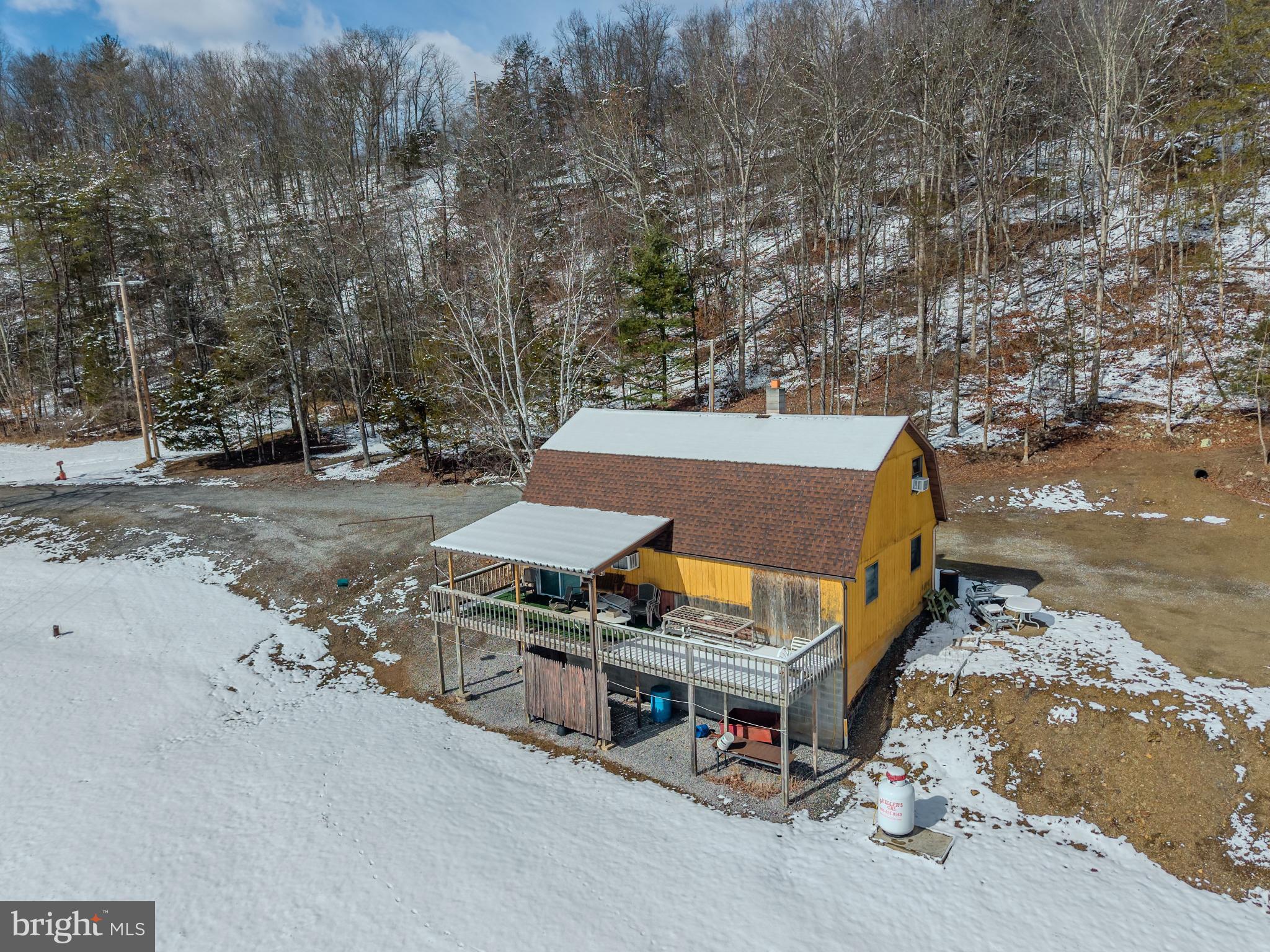 21697 View Drive Three Springs, PA 17264 - Photo 24 of 66 Charming yellow cabin nestled in snowy woods.