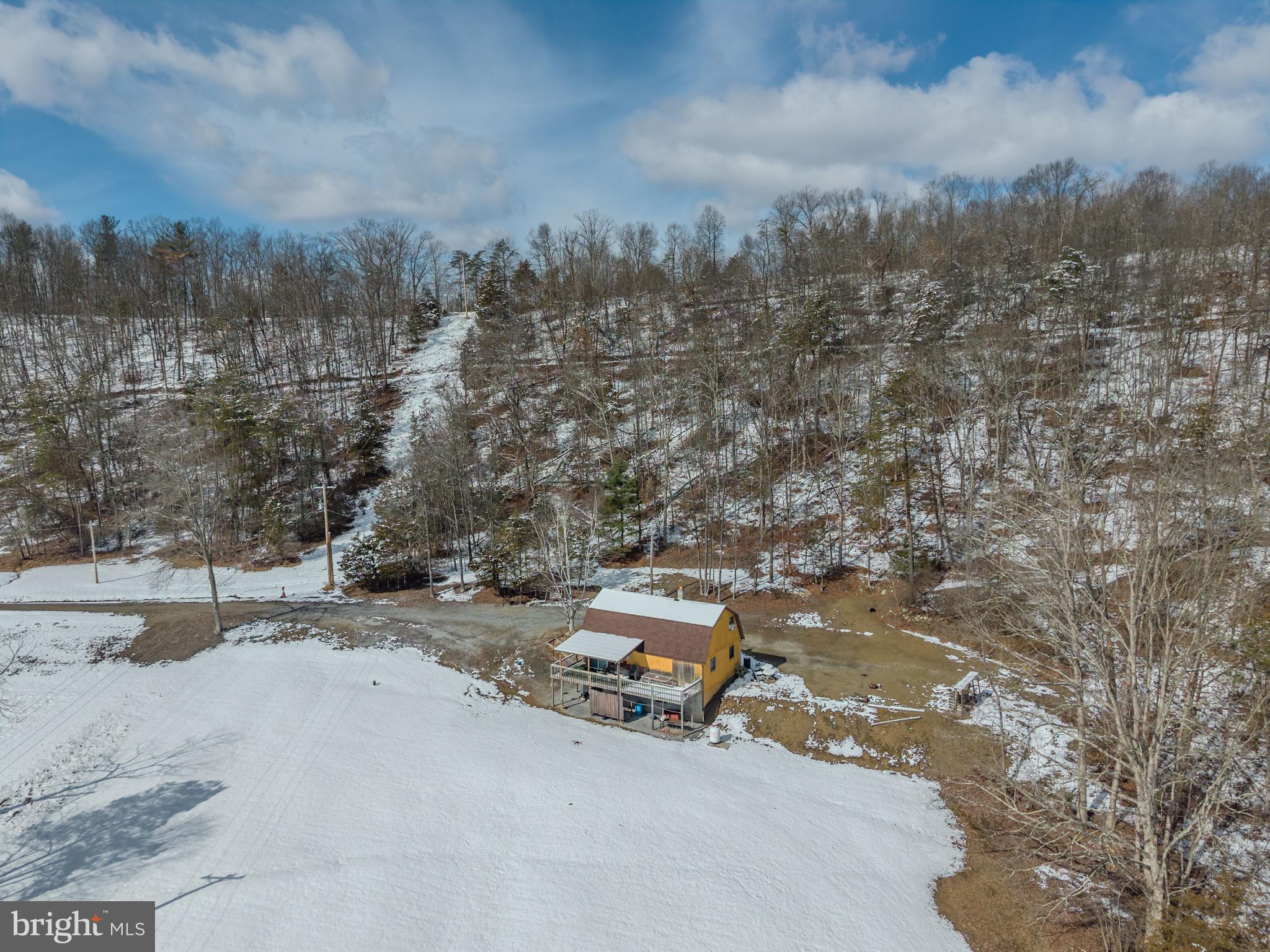 21697 View Drive Three Springs, PA 17264 - Photo 26 of 66 Charming cabin nestled in a snowy landscape.