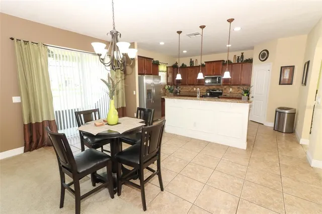 a dining room filled with stainless steel appliances kitchen island granite countertop furniture and a kitchen view