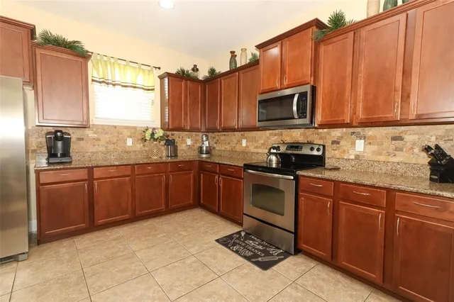 a kitchen with a sink a stove and cabinets