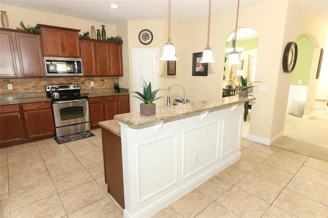 a kitchen with a sink a stove and cabinets
