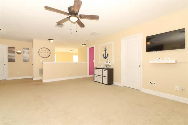 en empty room with ceiling fan and fan