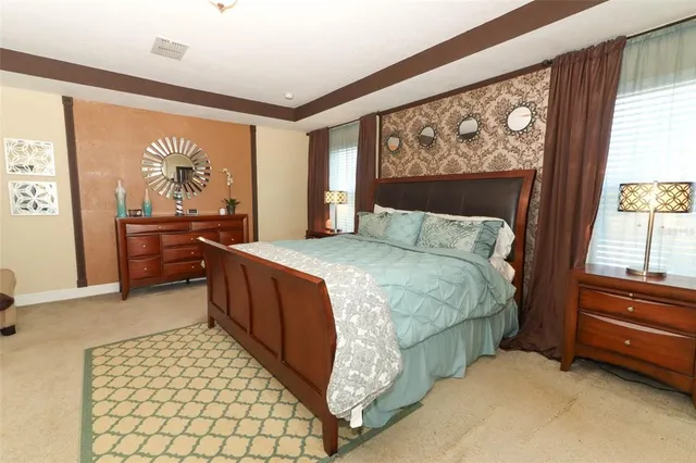 a bedroom with a bed and a large window