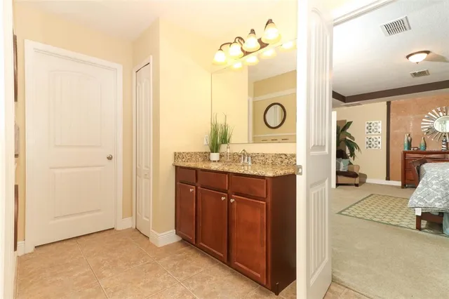 a spacious bathroom with a mirror and a sink