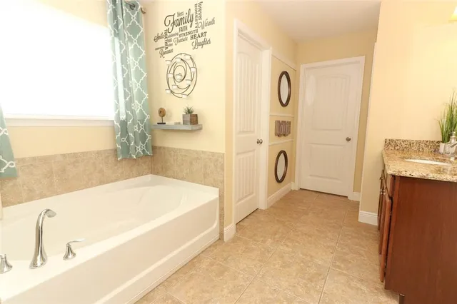 a bathroom with a tub sink and shower