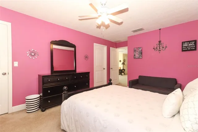 a bedroom with a bed and a dresser