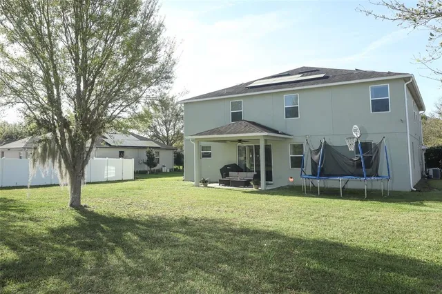 a view of a house with a yard and sitting area