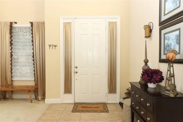 a view of hall way with mirror and furniture