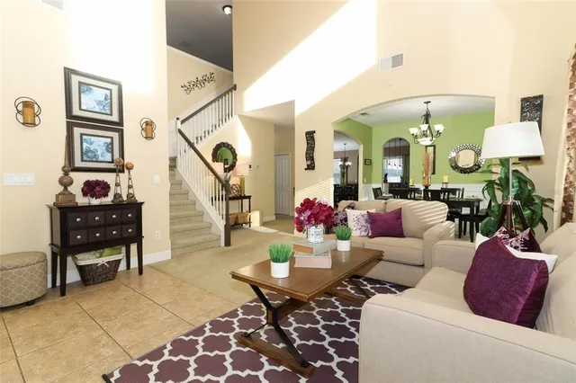 a living room with furniture and a chandelier