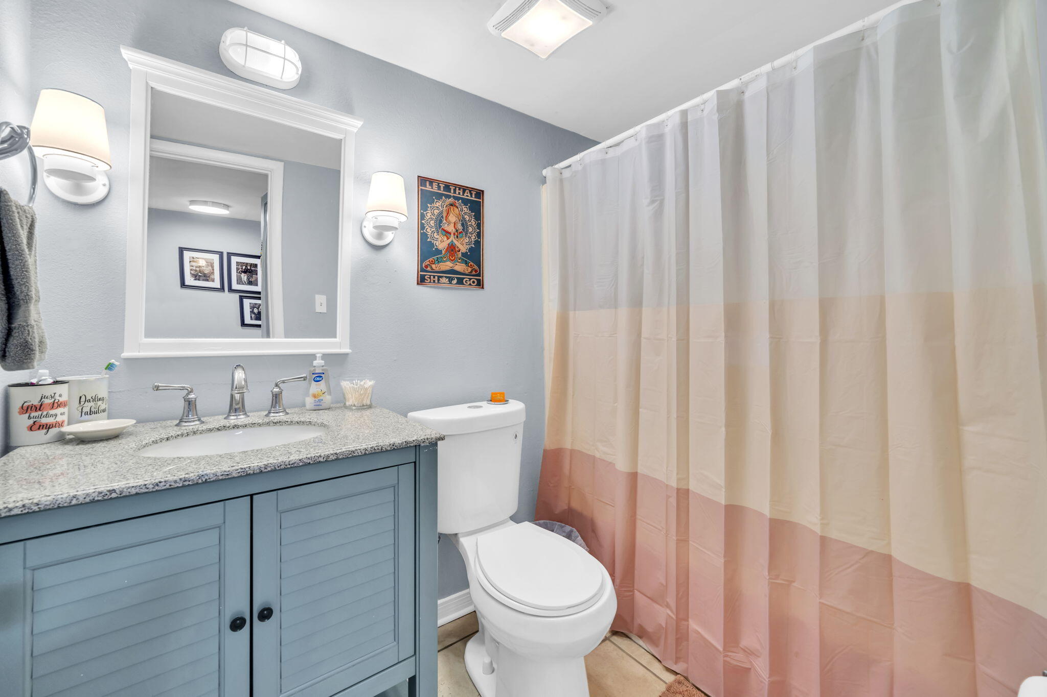 308 Miracle Strip Parkway Southwest, Unit 1B Fort Walton Beach, FL 32548 - Photo 21 of 42 a bathroom with a granite countertop sink and a toilet