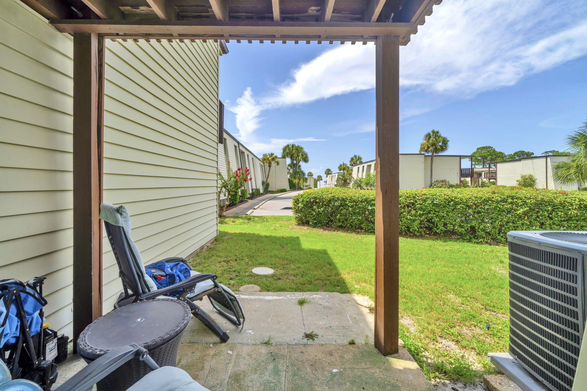 308 Miracle Strip Parkway Southwest, Unit 1B Fort Walton Beach, FL 32548 - Photo 22 of 42 a view of a porch with furniture and garden