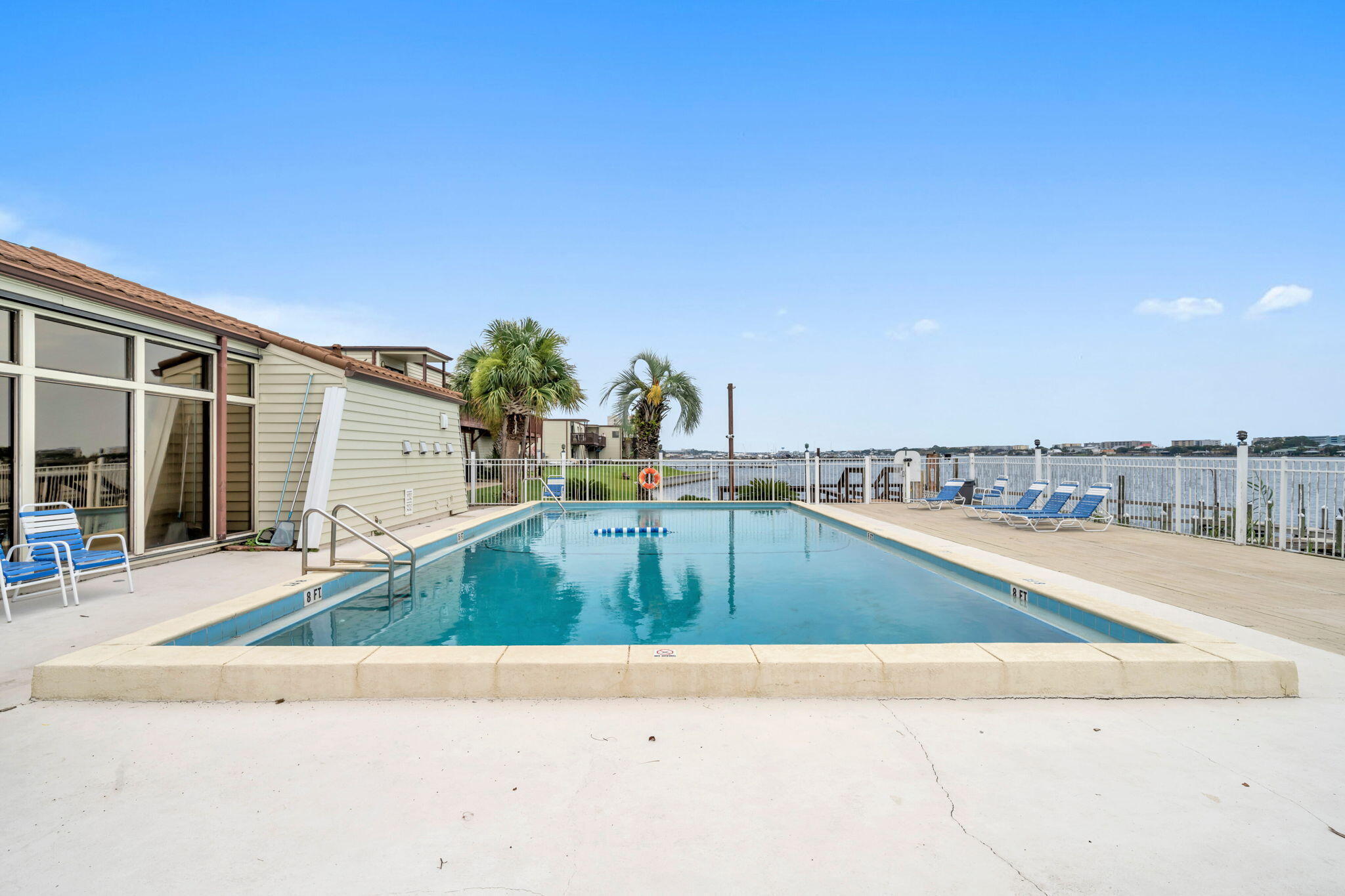 308 Miracle Strip Parkway Southwest, Unit 1B Fort Walton Beach, FL 32548 - Photo 26 of 42 a view of a swimming pool with a lounge chairs