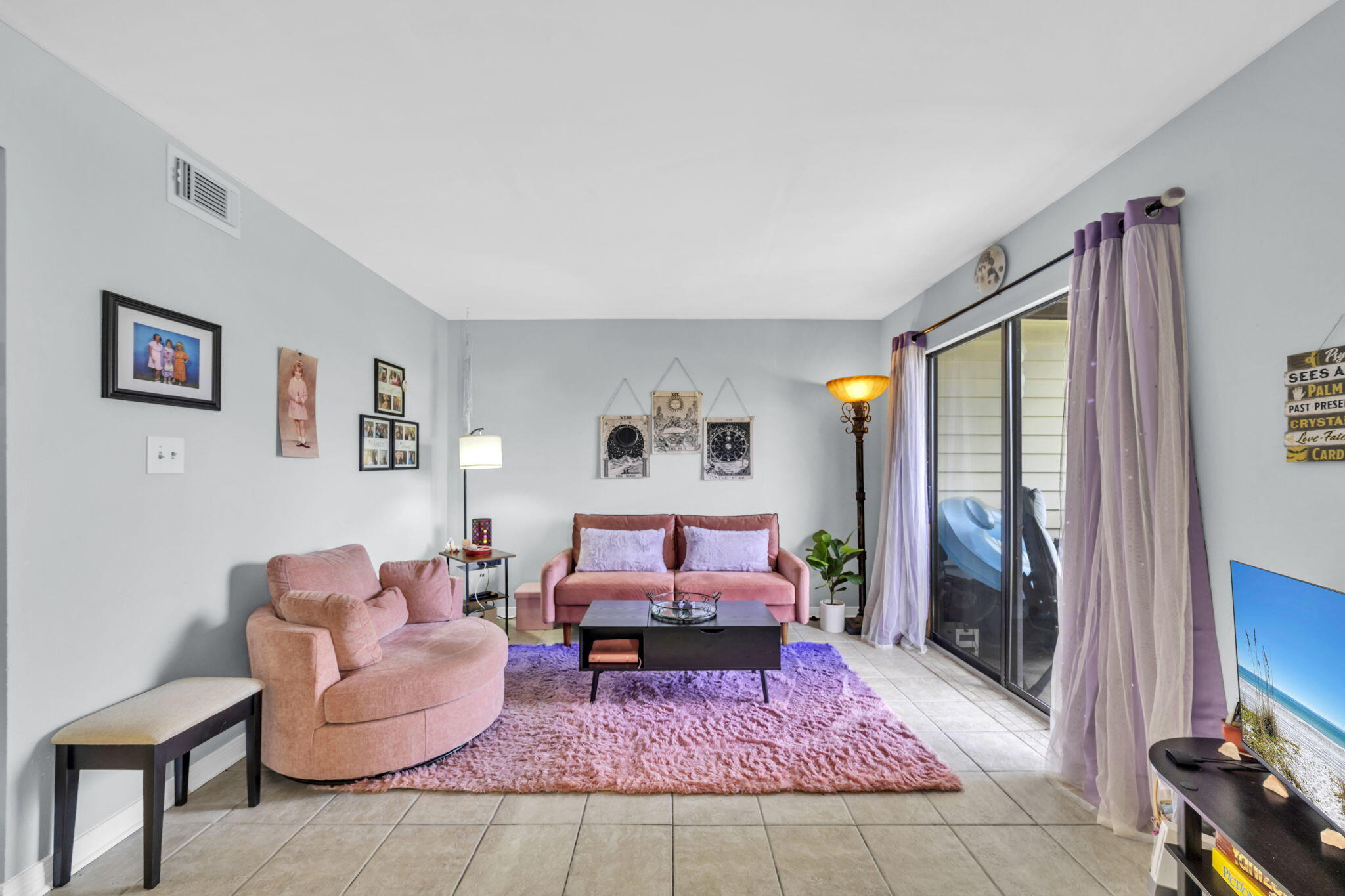 308 Miracle Strip Parkway Southwest, Unit 1B Fort Walton Beach, FL 32548 - Photo 10 of 42 a living room with furniture and a flat screen tv