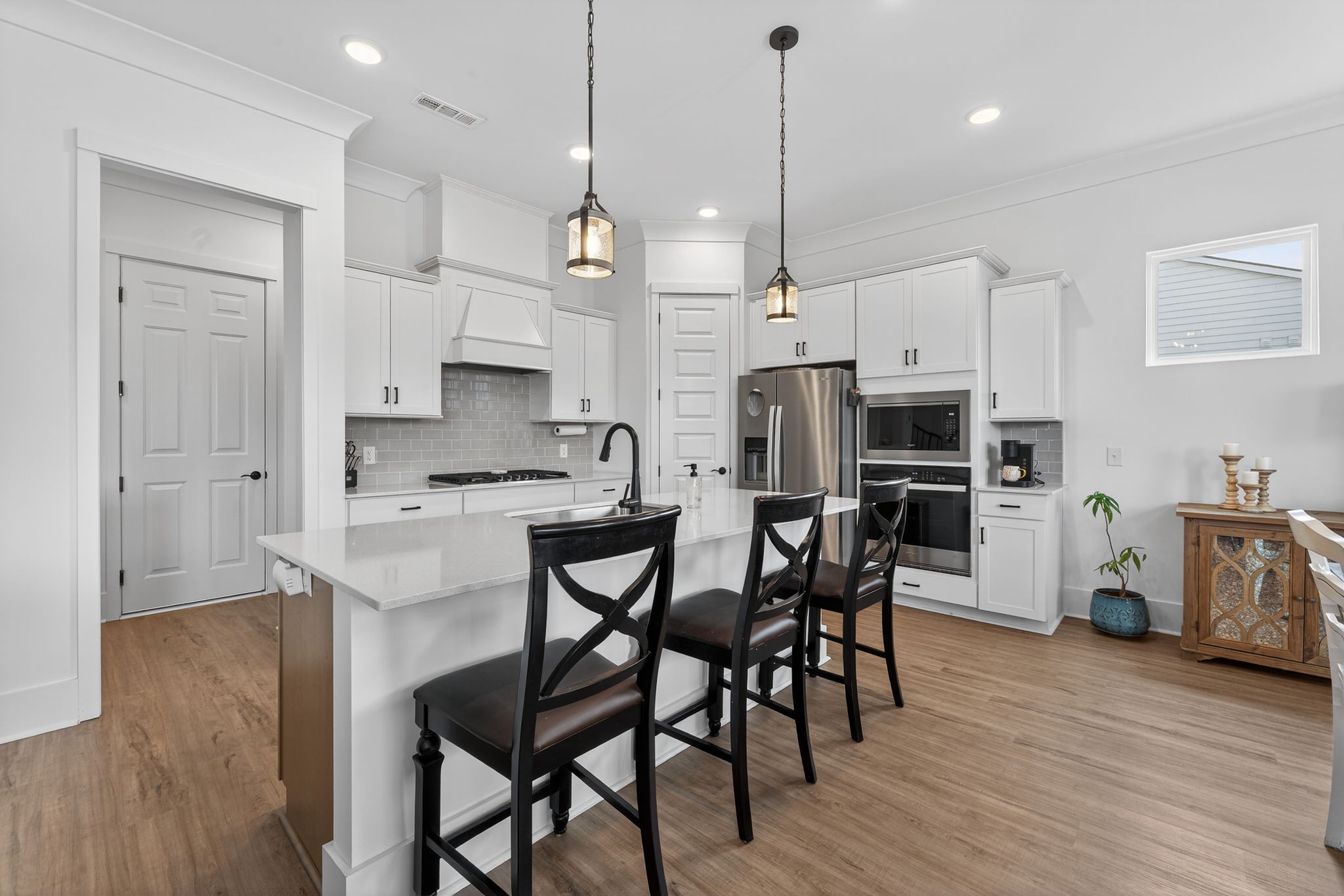 7780 Second Fiddle Way Arrington, TN 37014 - Photo 15 of 37 a kitchen with stainless steel appliances kitchen island granite countertop a dining table chairs refrigerator and sink