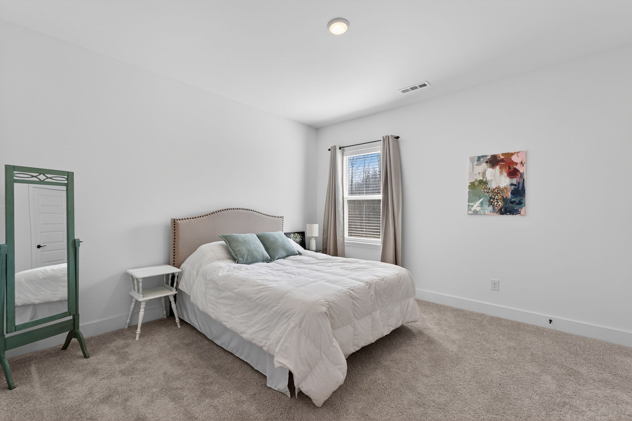 7780 Second Fiddle Way Arrington, TN 37014 - Photo 26 of 37 a large bed sitting in a bedroom next to a window