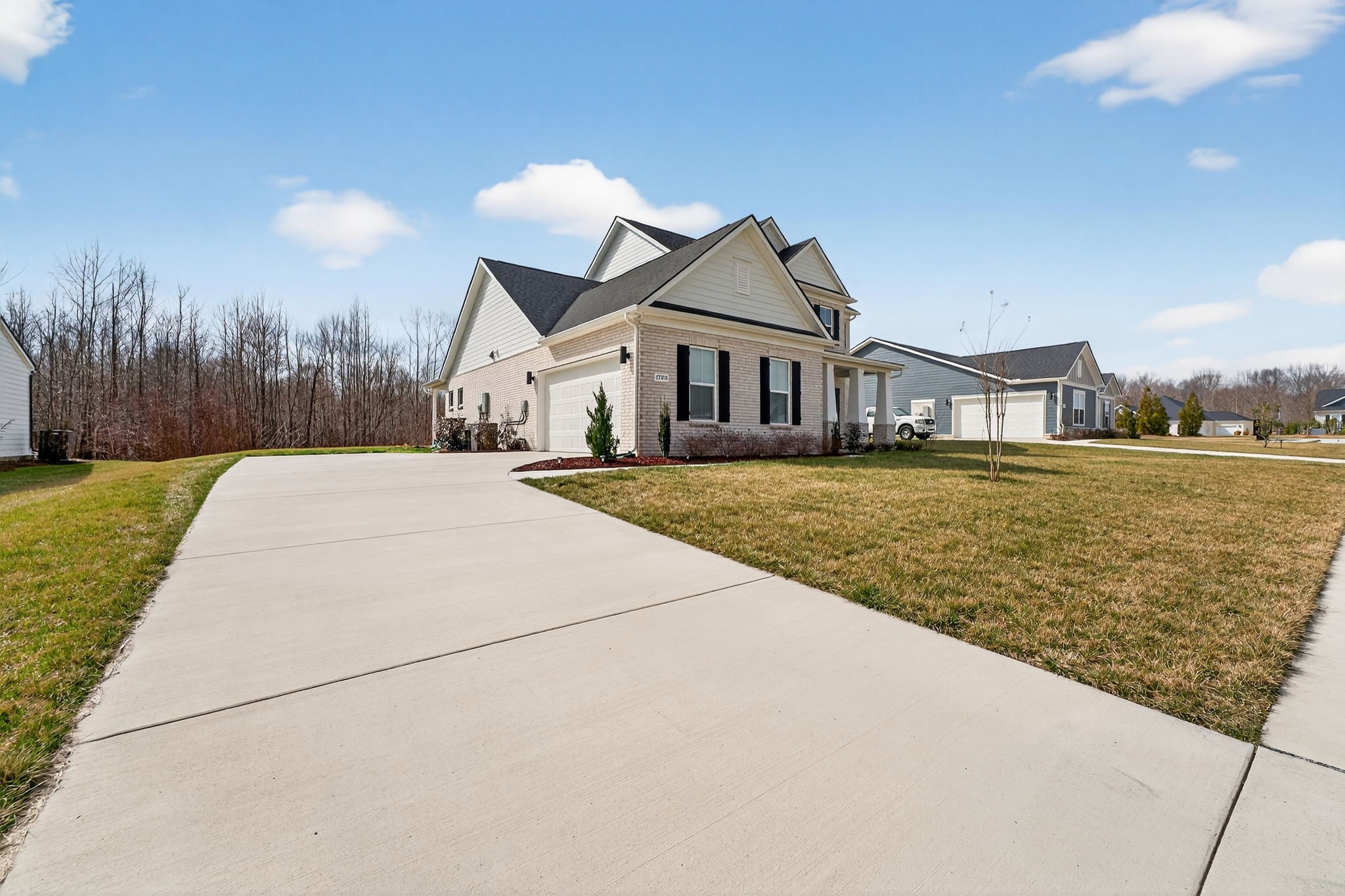 7780 Second Fiddle Way Arrington, TN 37014 - Photo 3 of 37 a view of a white house with a yard and potted plants