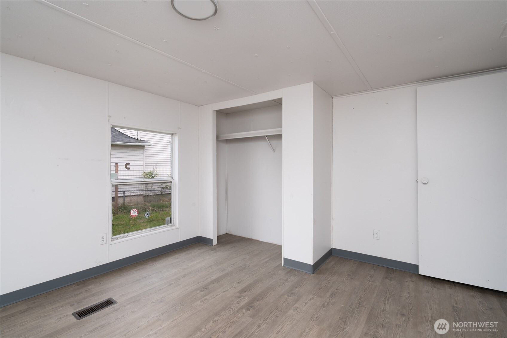 1133 State Street Sedro-Woolley, WA 98284 - Photo 13 of 28 a view of an empty room with closet and wooden floor