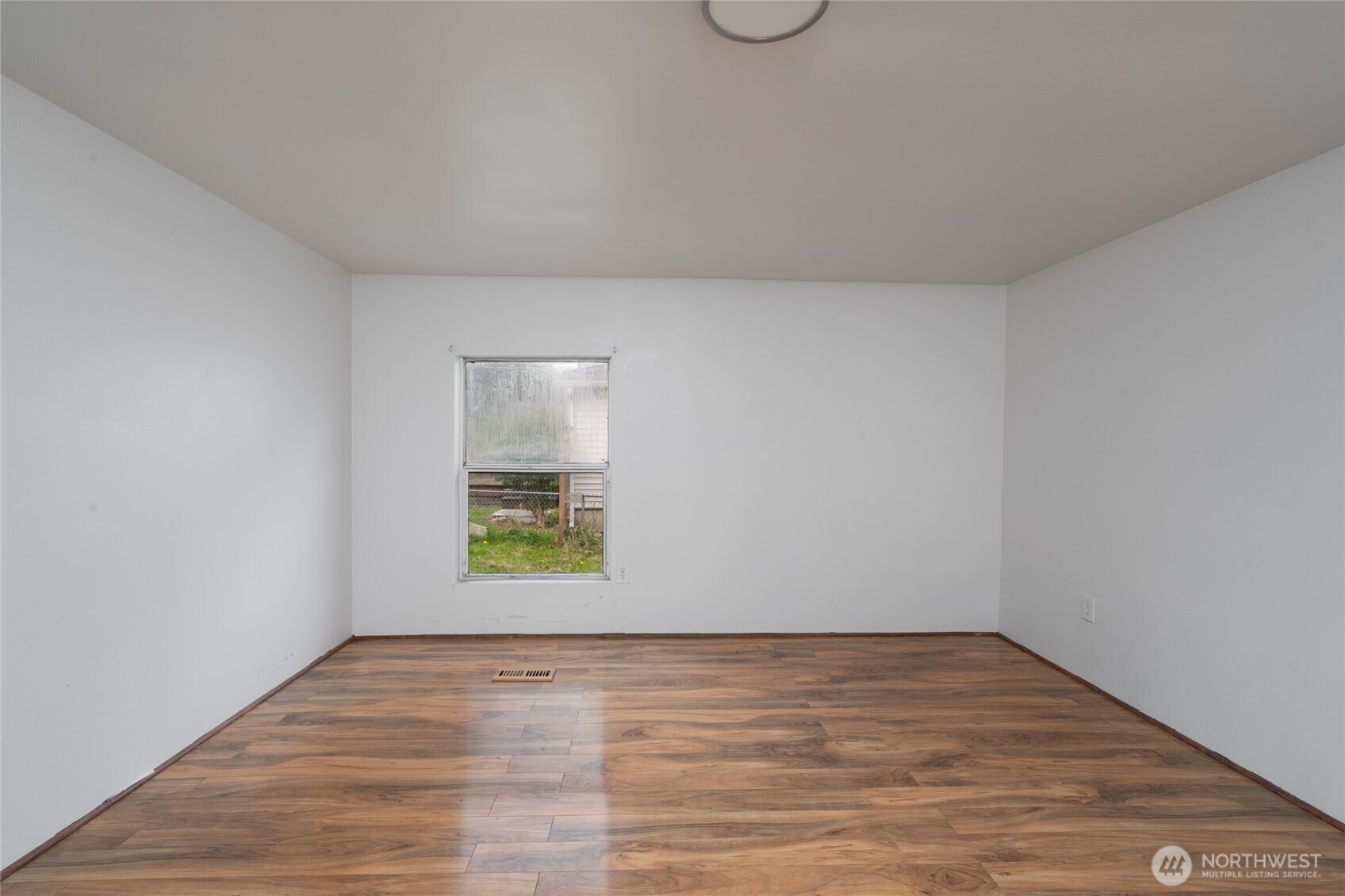 1133 State Street Sedro-Woolley, WA 98284 - Photo 14 of 28 a view of an empty room with wooden floor and a window