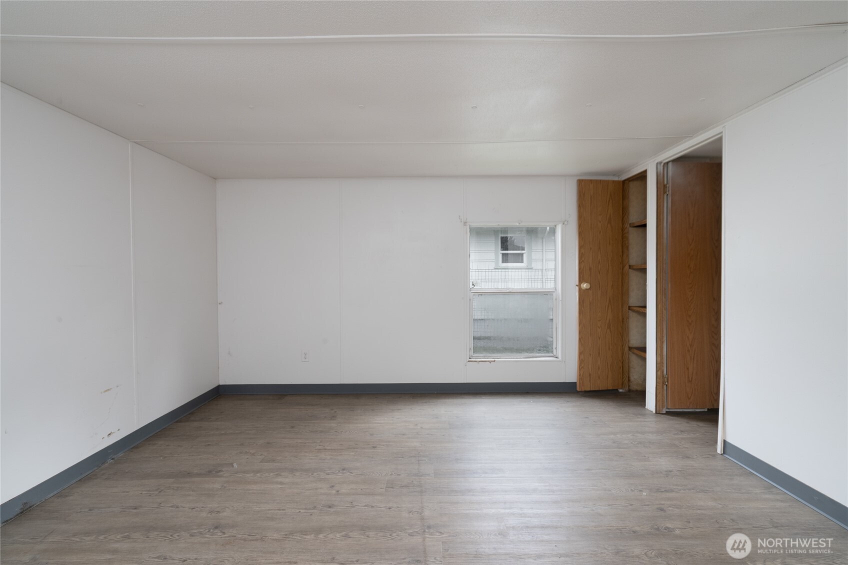 1133 State Street Sedro-Woolley, WA 98284 - Photo 16 of 28 a view of an empty room and closet with wooden floor