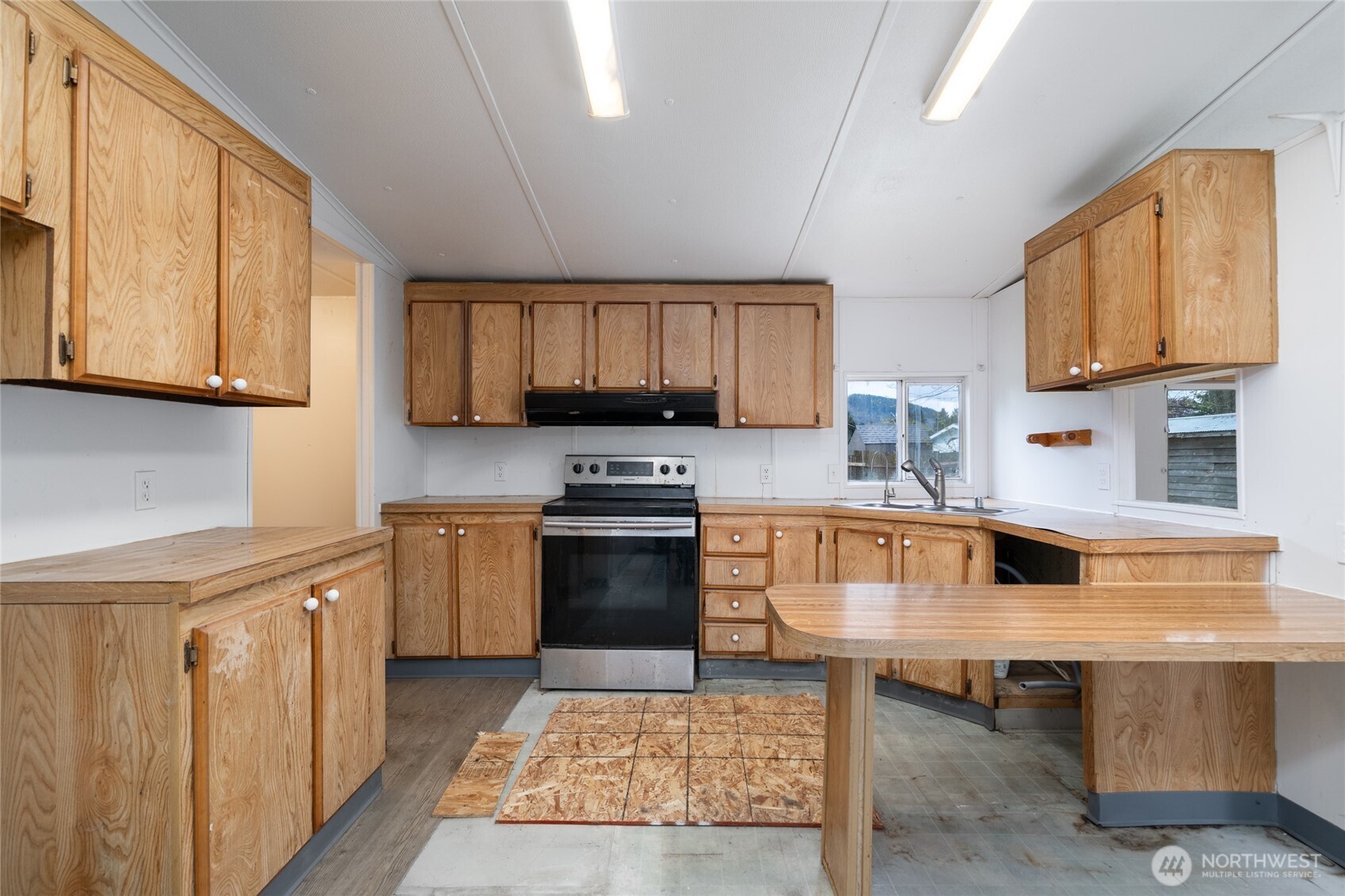 1133 State Street Sedro-Woolley, WA 98284 - Photo 9 of 28 a kitchen with stainless steel appliances granite countertop a stove top oven a sink dishwasher and cabinets with wooden floor