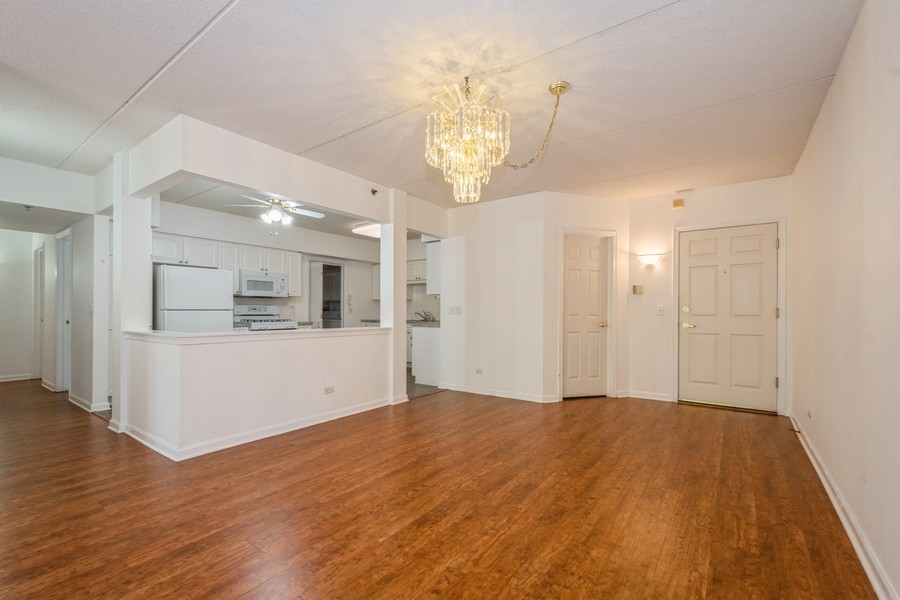 9220 East Prairie Road, Unit 303 Evanston, IL 60203 - Photo 4 of 13 a view of a kitchen with wooden floor and a kitchen