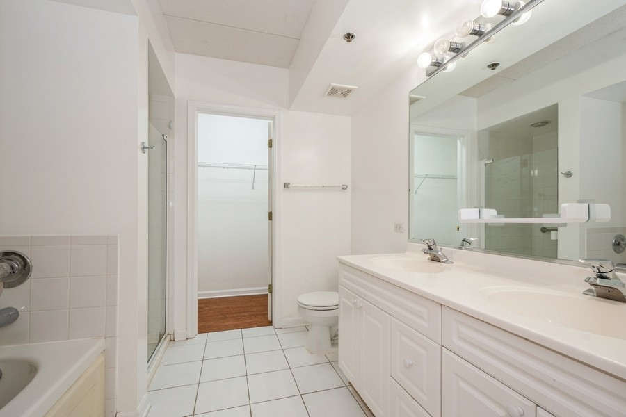 9220 East Prairie Road, Unit 303 Evanston, IL 60203 - Photo 7 of 13 a bathroom with a sink a toilet and shower