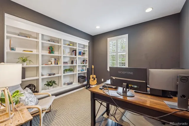 a workspace with furniture and a large window