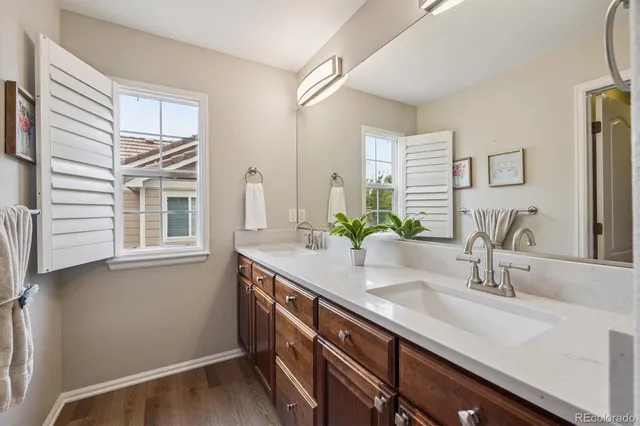 a bathroom with a double vanity sink and a mirror