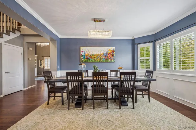 a view of a a dining room with furniture window and wooden floor